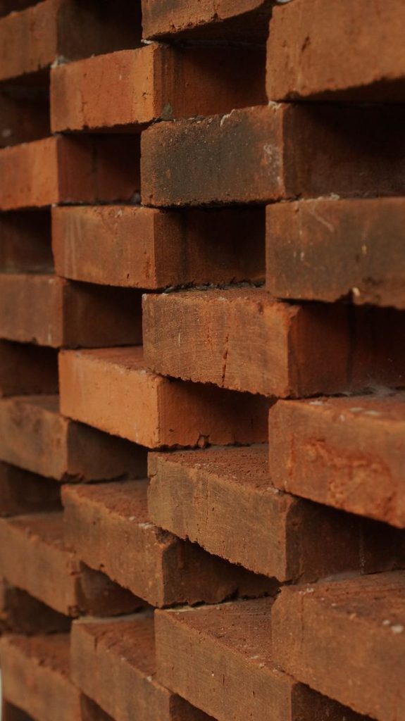 Mastering the First Impression: Your intriguing post title goes here Vertical stack of red clay bricks, ideal for construction and architecture visuals.